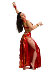 young girl in a red suit oriental dance in motion isolated on wh