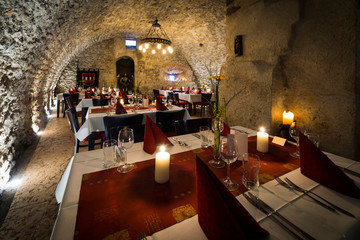 romantic arch stonewall in knight room with tables and candlelit