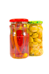 Fototapeta na wymiar pickled musroom and peppers in glass pots isolated on white