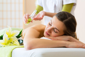 woman having wellness back massage in spa