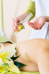 woman having wellness back massage in spa