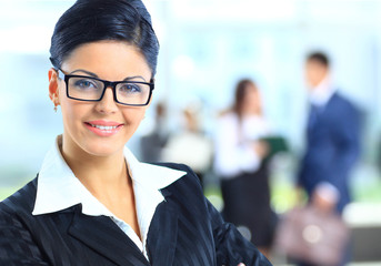 business woman standing with her staff in background