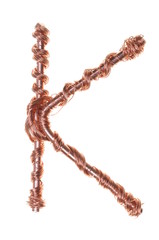 Twisted copper wire in the shape of the letter K