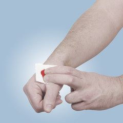 A person medically dressed with a cotton ball and bandage over a