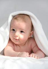 baby under white blanket