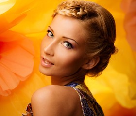 Beautiful young cheerful blond woman in colorful dress
