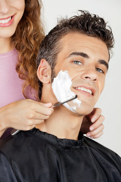 Man Getting A Shave From Barber