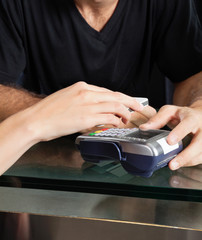 Customer Paying With Mobilephone Over Electronic Reader At Salon