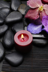 Fototapeta na wymiar spa concept -burning candle and pebble with orchid