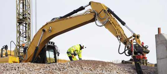 bulldozer and building workers in action © christian42