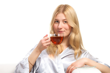 Blonde woman drinking a cup of tea