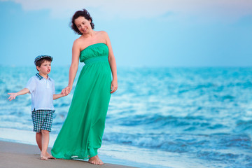 Mother and her little son enjoying beach