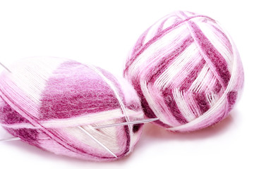 Varicolored balloons of yarn with knitting needles