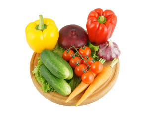 Vegetables on wooden cutting board isolated on white