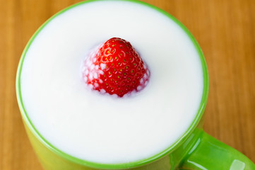 sweet strawberry in a glass of kefir
