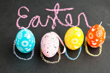Colorful Easter egg shaped candles and text