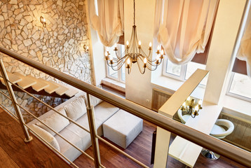 Fototapeta na wymiar Modern art nouveau style two-high living-room interior with stai