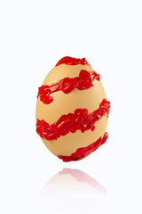 Spiral red paint stroke on the egg