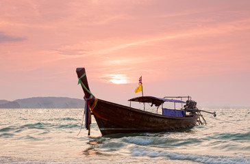 Longtail boats against a sunset. Ao-Nang, Thailand.