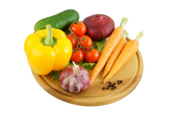Vegetables on wooden cutting board isolated on white