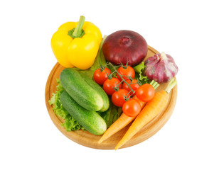 Vegetables on wooden cutting board isolated on white