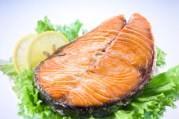salmon steak with salad and lemon
