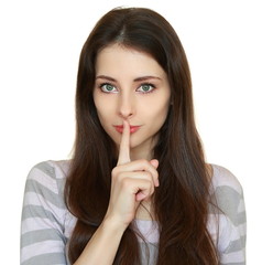 Beautiful woman showing silent sign and holding finger over lips