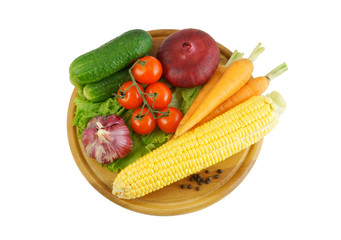 Vegetables on wooden cutting board isolated on white