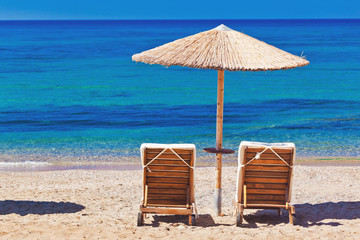 view of the beach with chairs and umbrellas