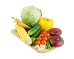 Vegetables on wooden cutting board isolated on white