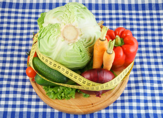 Vegetables with measuring tape, diet concept