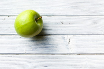 green apple on white kitchen table