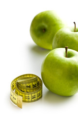 green apple and measuring tape