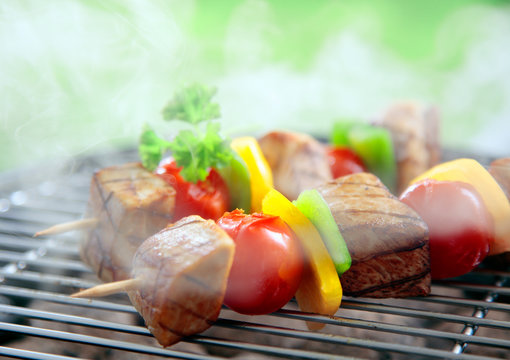 Beef kebabs cooking on a grill