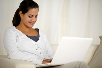 Young woman browsing the internet on laptop
