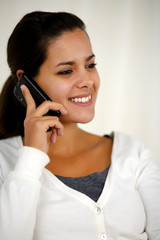 Beautiful young woman speaking on cellphone