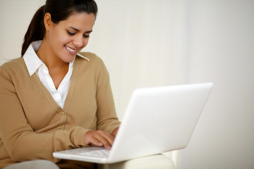 Smiling young woman working with laptop computer