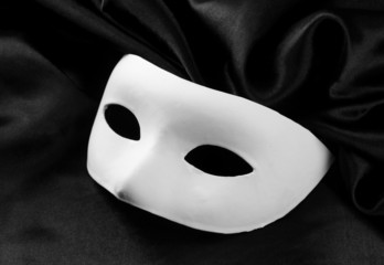 White mask, on black silk fabric