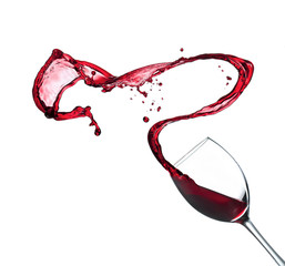 Red wine splashing from glass, isolated on white background