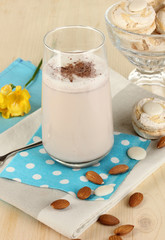 Glass of chocolate-cream cocktail on wooden table close-up