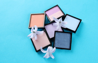 Beautiful bright eye shadows on blue background