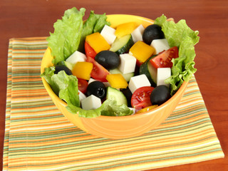 Tasty Greek salad on wooden background