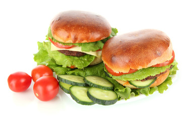 Big and tasty hamburgers on plate isolated on white