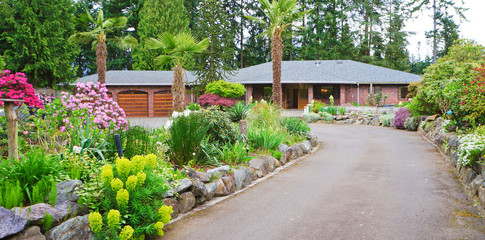 Road with brick house and spring landscape.