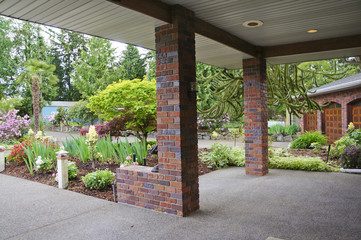 Covered entrance porch with front yard in spring