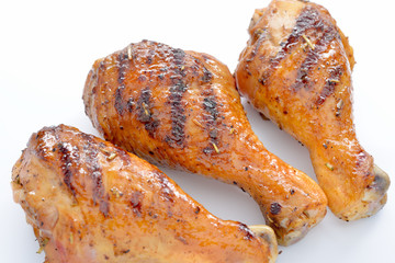 Grilled chicken leg on white background.