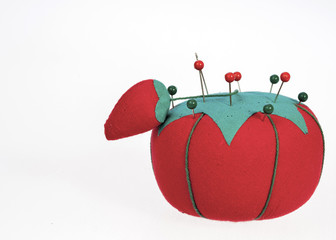 red and green pincushion and pins