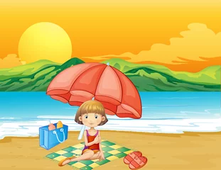 Deurstickers Een meisje met een boek op het strand © GraphicsRF