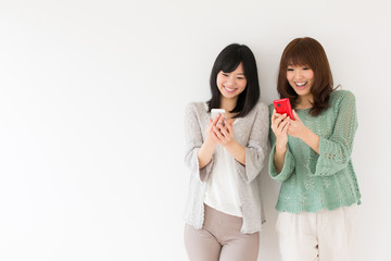 attractive asian women using smart phone in the room