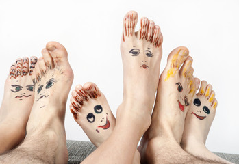 Family. Feet with smiling mugs